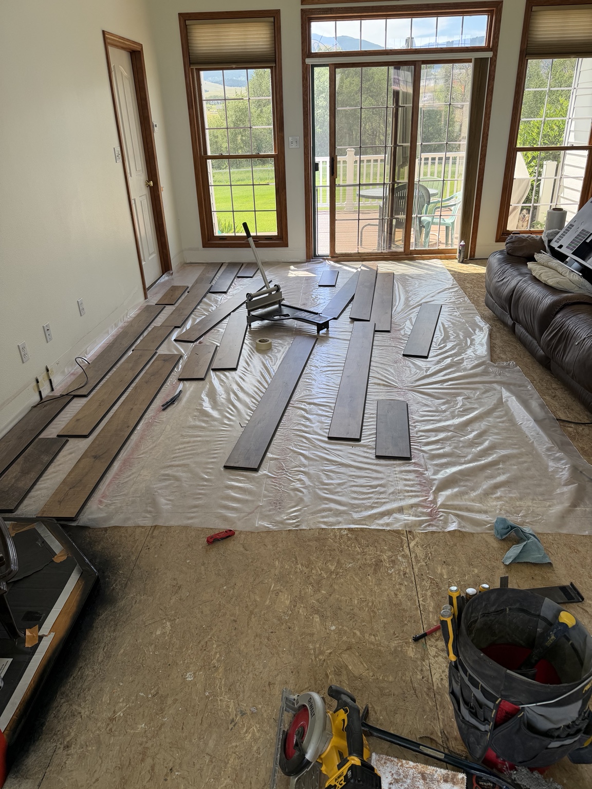 Laminate planks laid out for installation across the living room