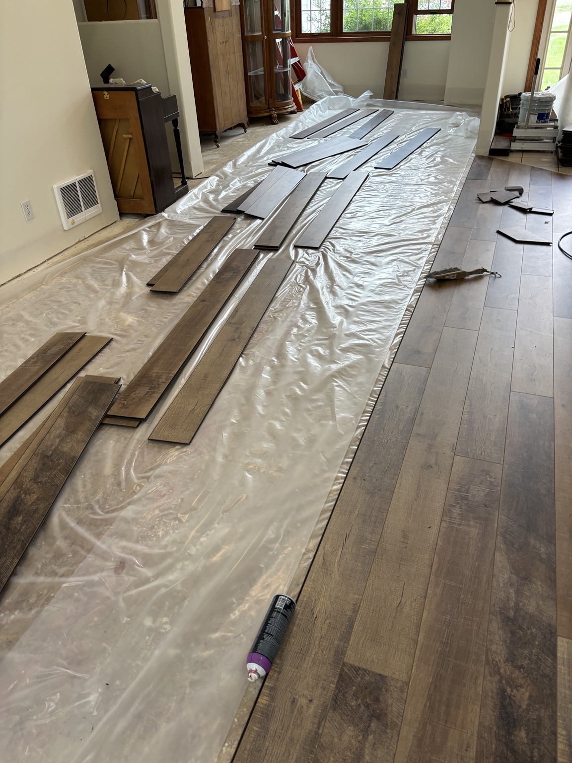 Laminate flooring installation progressing across the living space